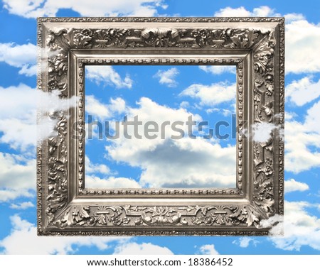Silver picture frame against a blue sky with puffy clouds