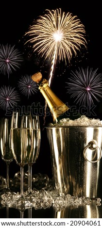 Glasses of champagne with fireworks on black background