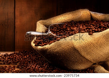 Coffee beans in burlap sack with antique wood background