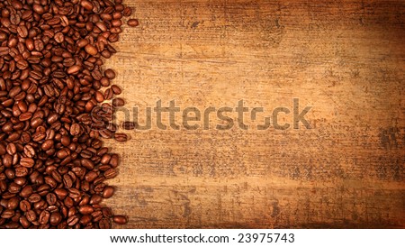 Roasted coffee beans on rustic wood background