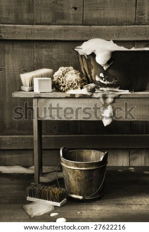 Old wash tub with soap and scrub brushes /BW