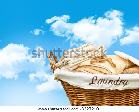 Laundry basket with towels against a blue sky