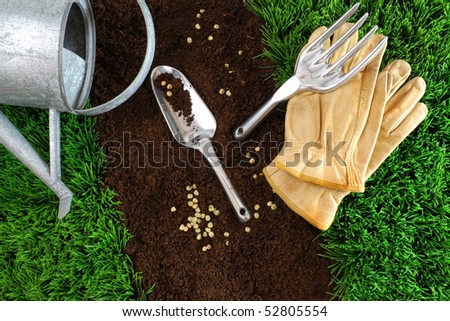 Assortment of garden tools with earth and grass