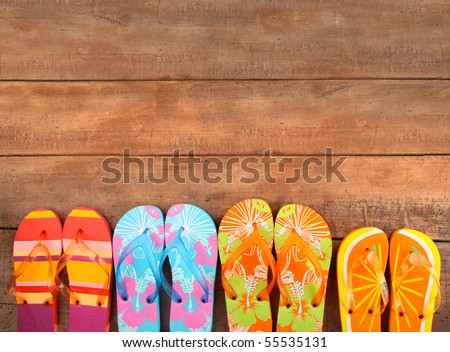 Brightly colored flip-flops on wood