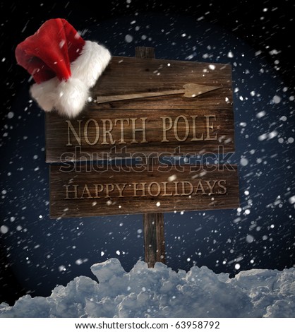 Weathered wooden sign with Santa hat on snowy background