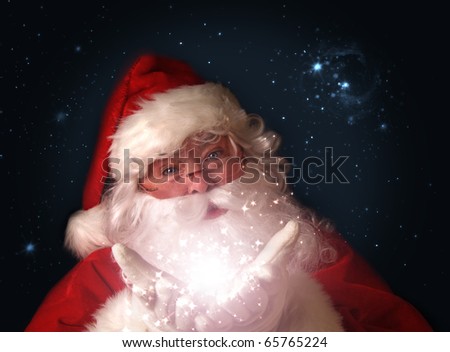 Santa holding magical Christmas lights in hands