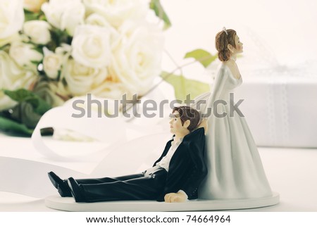 stock photo Closeup of whimsical wedding cake figurines on white