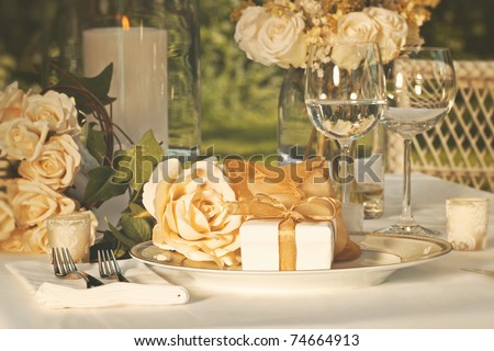 stock photo Gold wedding party favors on plate at reception