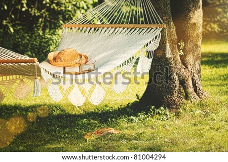 View of hammock and book on a sunny summer day