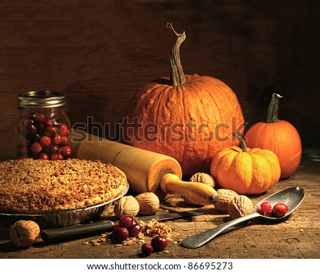 Freshly baked pie with pumpkin , nuts and cranberries on rustic table