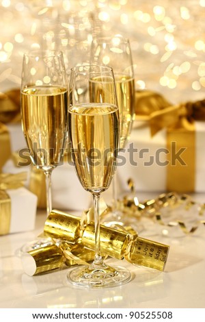 Glass of champagne against gold sparkle background