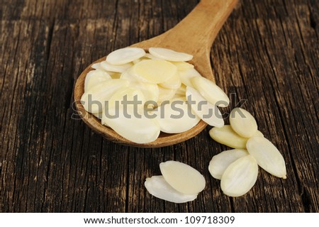 sliced almonds on wood spoon - almonds on wood spoon
