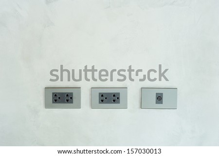 electrical outlet on on cement wall - plug and analog tv plug