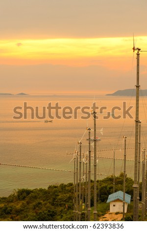 Wind power under sunset near sea shore , wind electric generator