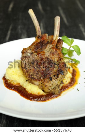 Lamb Chops on mashed potato with pepper,tomato sauce,juicy