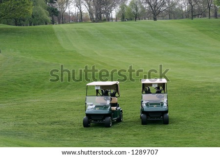 two empty golf carts on golf course
