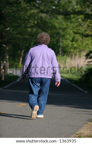 older woman walking on path