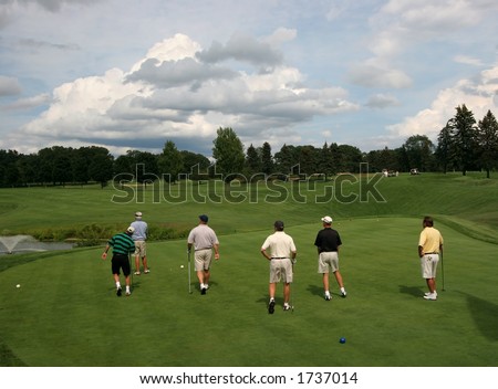 six men playing golf