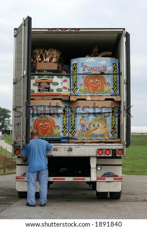 truck packed with boxes filled with pumpkins