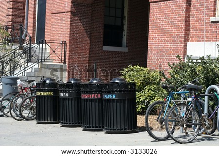 trash cans and bikes outside building on college campus