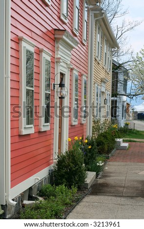 view down sidewalk with houses and flowers