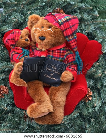 adorable holiday father or grandfather stuffed bear reading story to little bear