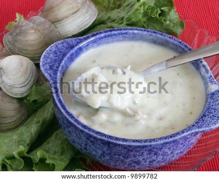 clam chowder soup with whole clams on lettuce