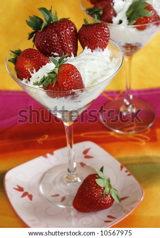 strawberries and whipped cream in martini glasses
