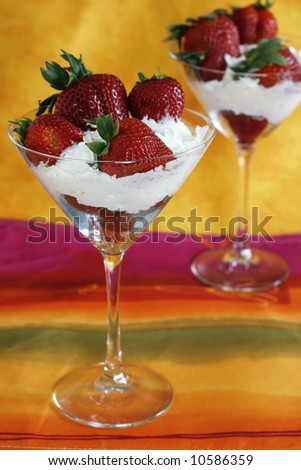 strawberries and whipped cream in martini glasses