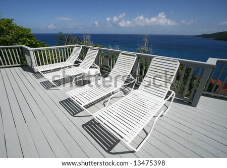lounge chairs on deck overlooking ocean