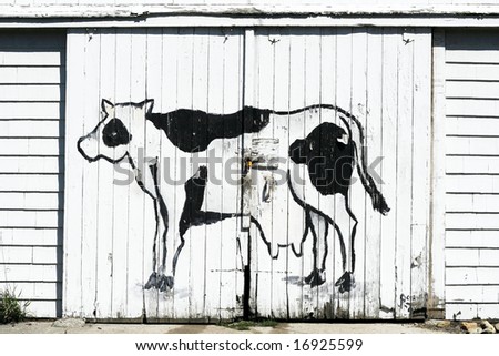 cow painted on side of barn doors
