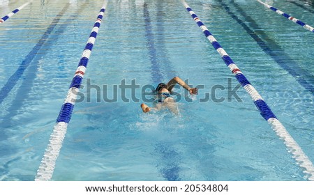 woman swimming laps in pool