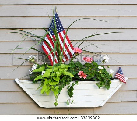 boat planter with flowers and american flags