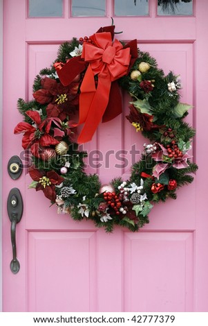 holiday wreath on pink door