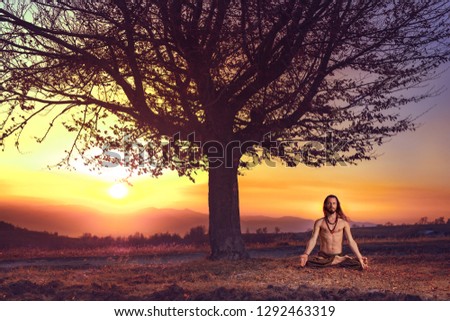 Yogi man meditating at sunset on the hills. Lifestyle emotional relaxation emotional concept spirituality harmony with nature