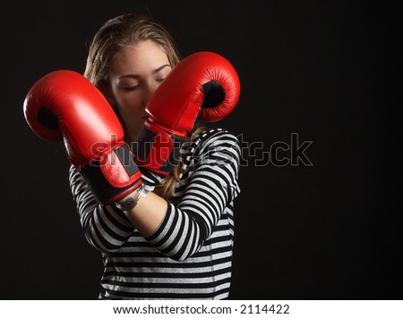 Sexy young woman over black background with boxing gloves