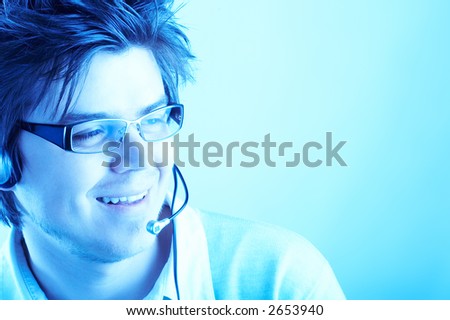 Attractive Customer Representative with headset smiling during a telephone conversation