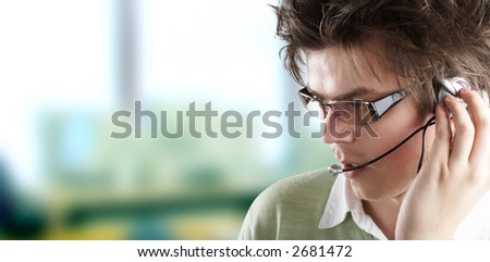 Attractive Customer Representative with headset smiling during a telephone conversation