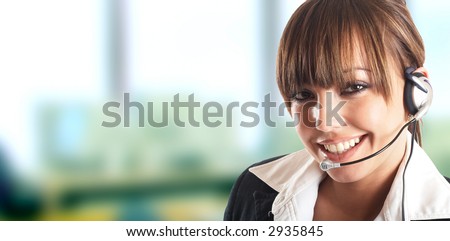 Beautiful Customer Representative with headset smiling during a telephone conversation Beautiful Customer Representative with headset smiling during a telephone conversation