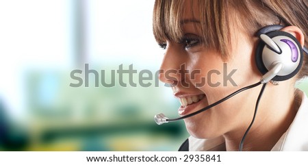 Beautiful Customer Representative with headset smiling during a telephone conversation