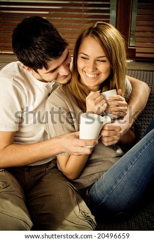 stock photo : Happy young couple having fun on the sofa