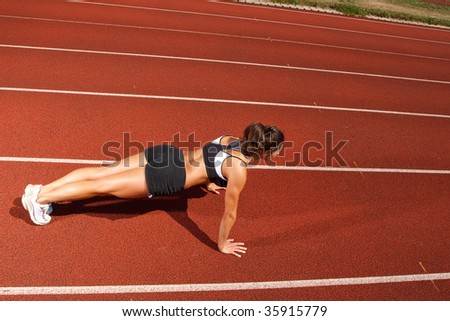 Athletic woman working out on track