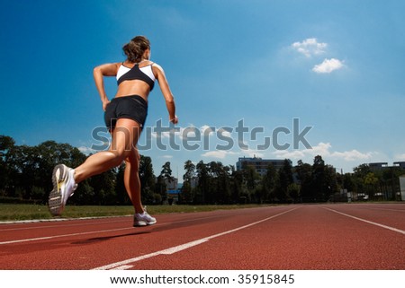 stock photo : Athletic woman running on track