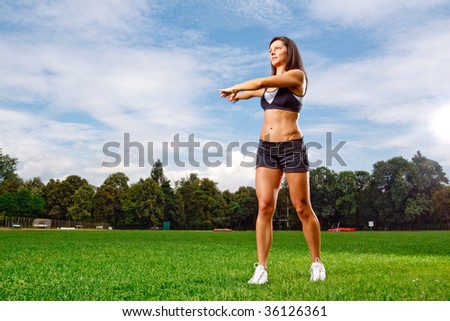 Athletic woman working out on field