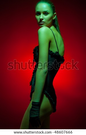 Glamorous image of fashion model in studio shot with colored gels for special effect