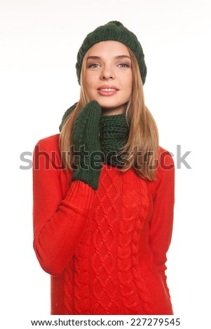 Model in the red dress, green scarf,mittens and hat  posing isolated on white