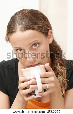 Fifteen year old girl is drinking coffee