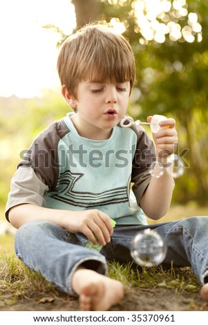 Five years old boy makes soapbubbles