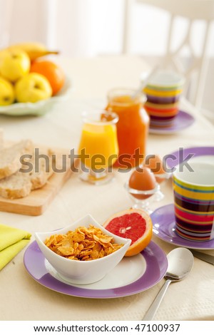 Breakfast with juice, fruits, jam and eggs