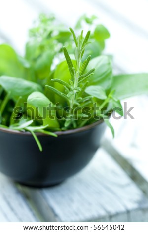 bunch of herbs in a small bowl
